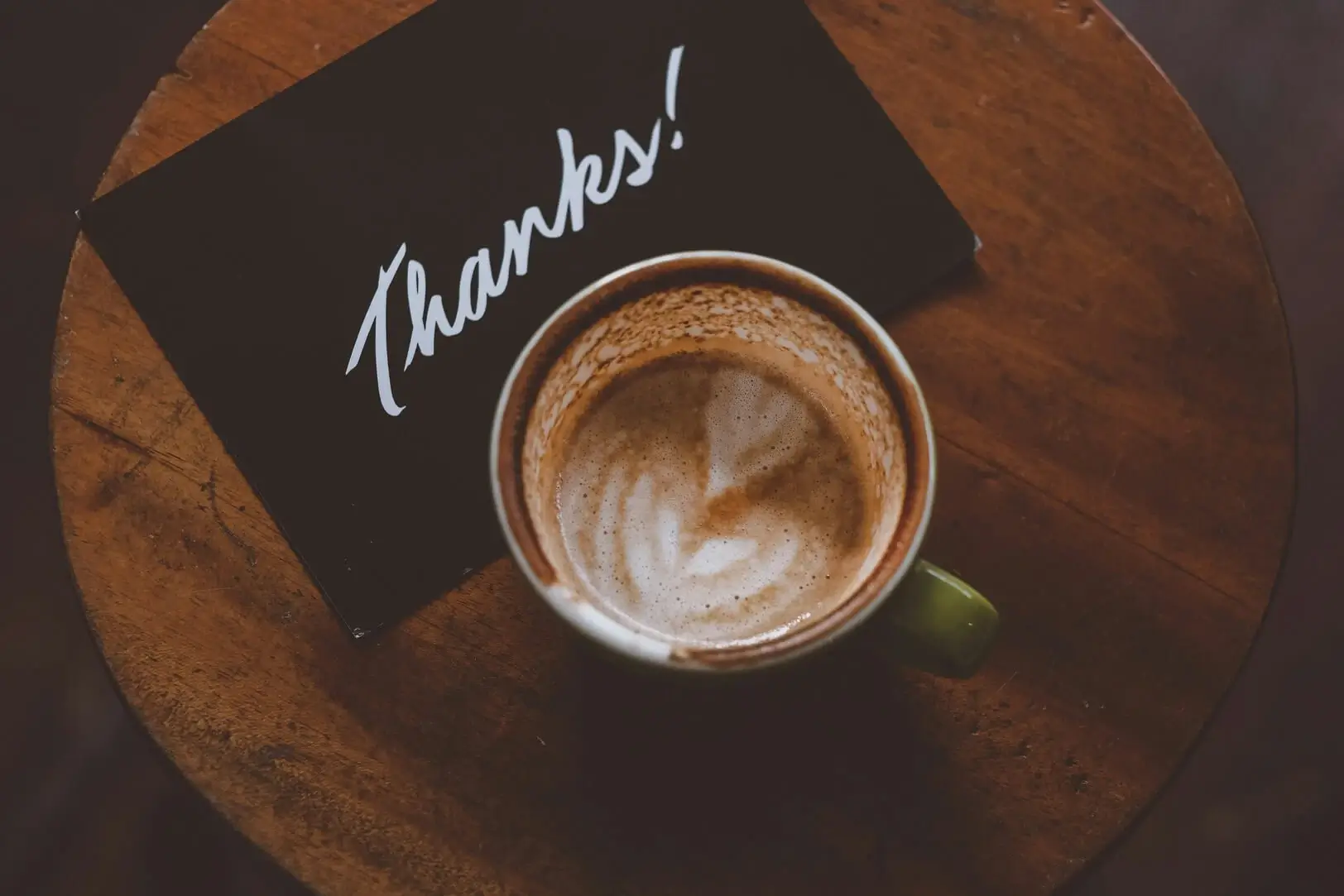 Thank-you note under a cup of coffee